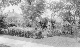 Hattie and daughter Mildred, Roy at flower garden 1618 N street 1921