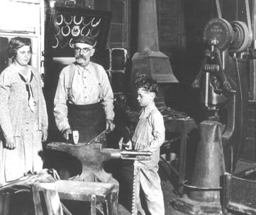 William Siebler inside his blacksmith shop with youngest daughter 